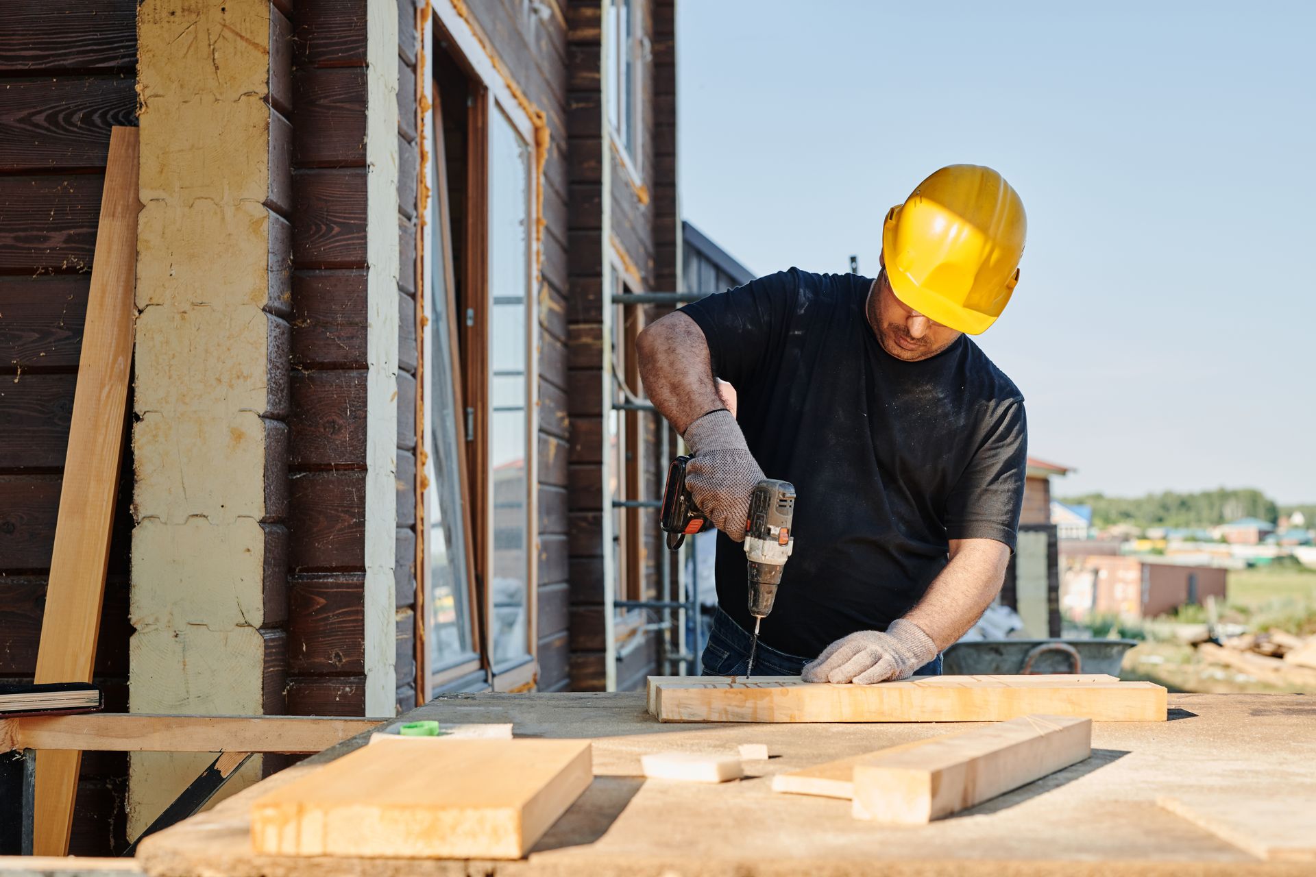 Contractor drilling into a structural beam on a commercial buildout job site in Houston (illustrative photo, not an actual job site)